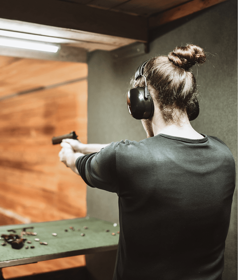Shooter aiming with earmuffs on