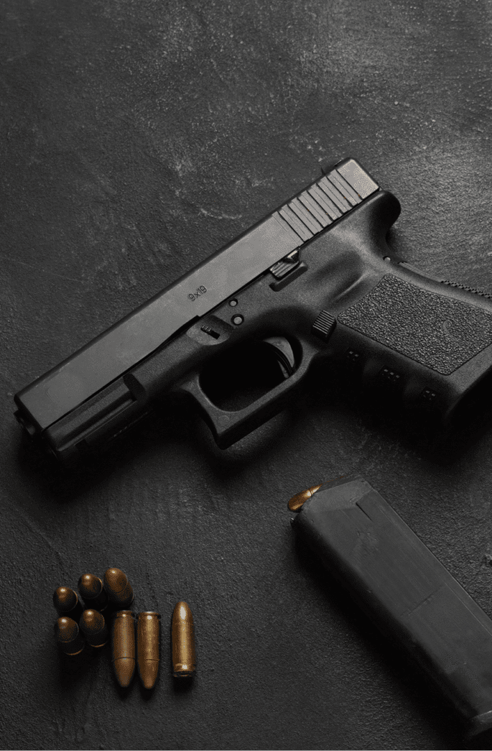 Handgun with magazine and bullets on table
